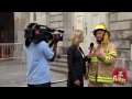 Fireman Interviewed While Building Burns